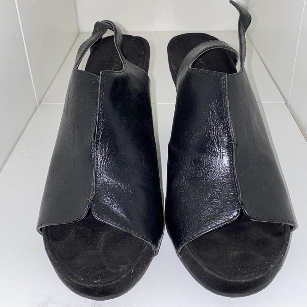 New, never worn. Black wedges.